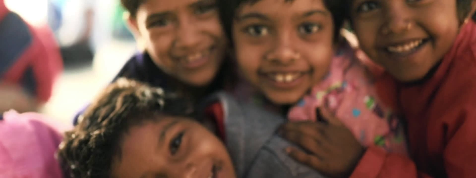 A group of children smiling in a Brevitas Media film